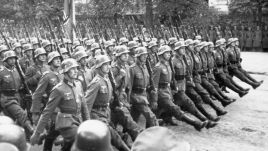 German soldiers march through a street in Poland after the invasion of Poland in 1939. Photo by: Corbis via Getty Images.