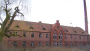 Owińska’s neo-Gothic brick buildings brood over windswept fields filled with tangled vegetation. Photo: Wikicommons / Rzuwig