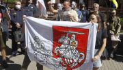 <b>Belarus’ historic coat of arms <em>Pahonia</em> is among the symbols banned by the regime.</b> Here seen at a demonstration in front of the Belarusian embassy in Kyiv in August 2020. Photo: Pavlo Gonchar/SOPA Images/LightRocket via Getty Images