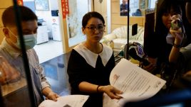 An employee of the Taiwanese company 'Gold Apollo' distributes their official statement in New Taipei City, Taiwan, September 18, 2024. Photo: PAP/EPA/RITCHIE B. TONGO 