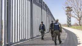 Greek border police walking alongside the fortification fence constructed next to Evros river between Greece and Turkey to prevent unauthorized illegal entry of migrants. Photo: Nicolas Economou/NurPhoto via Getty Images