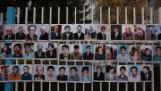 Photographs of the missing people from the Kosovo War posted in a street in Pristina, Kosovo. Photo: Marco Di Lauro/Getty Images.