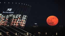 Pink Supermoon is seen rising near the National Stadium in Warsaw, Poland on April 27, 2021. Photo by STR/NurPhoto via Getty Images