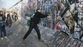 A man helps destroy the Berlin Wall in November 1989. Photo: Jacques Langevin/Sygma/Sygma via Getty Images