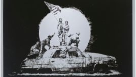 The piece, entitled Gold Flag, blends Banksy’s characteristic wit with a social message.  Photo via banksyexplained.com