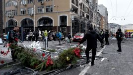 Men remove Christmas decorations from a street in Kyiv affected by a Russian missile attack. Photo by Ukrinform/ Getty Images 